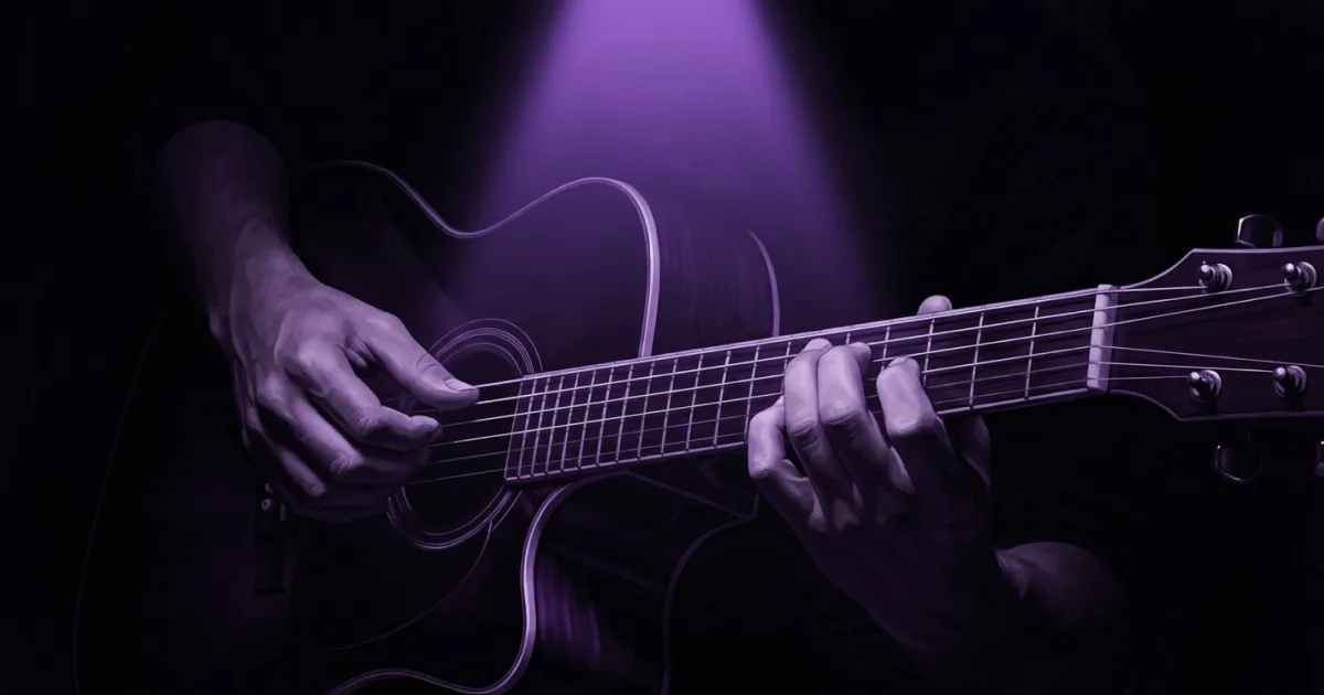Close-up of hands on guitar strings lit by purple spotlight — deliberate practice in action
